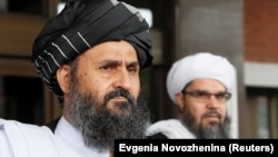 FILE: Taliban chief negotiator Mullah Abdul Ghani Baradar (front) leaves after peace talks with Afghan senior politicians in Moscow in May 2019.