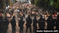 Припадници на жандармеријата чуваат улица за време на антивладин протест во близина на просториите на Српската напредна партија во Белград, Србија, на 14 август 2025 година