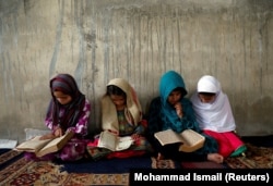 Afghan girls read the Koran at a madrasah. (file photo)