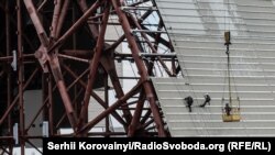 Люди працюють на покрівлі конфайнмента