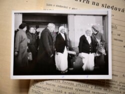 Одна з папок, до якої Радіо Вільна Європа/Радіо Свобода отримало доступ, з фотографією Матері Терези (друга праворуч) під час відвідин нею Праги в 1984 році. В нотатках в її папці зазначено, що таємна поліція хотіла задокументувати, хто вітав відому католицьку сестру, коли та прилетіла в країну