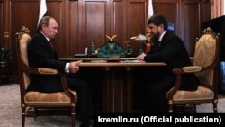 Russian President Vladimir Putin talking to Chechen leader Ramzan Kadyrov on March 25 in the Kremlin.