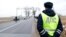RUSSIA -- Migrant workers from Kyrgyzstan harvest potatoes in a private field in the Beryozovsky district of Krasnoyarsk region, September 8, 2017A traffic police officer at a regional weigh station near the village of Rodniki, January 24, 2017