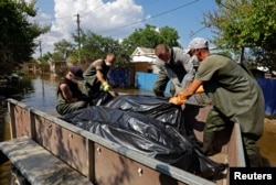 Російські рятувальники та волонтери збирають тіла загиблих під час повені у Голій Пристані, 16 червня 2023 року