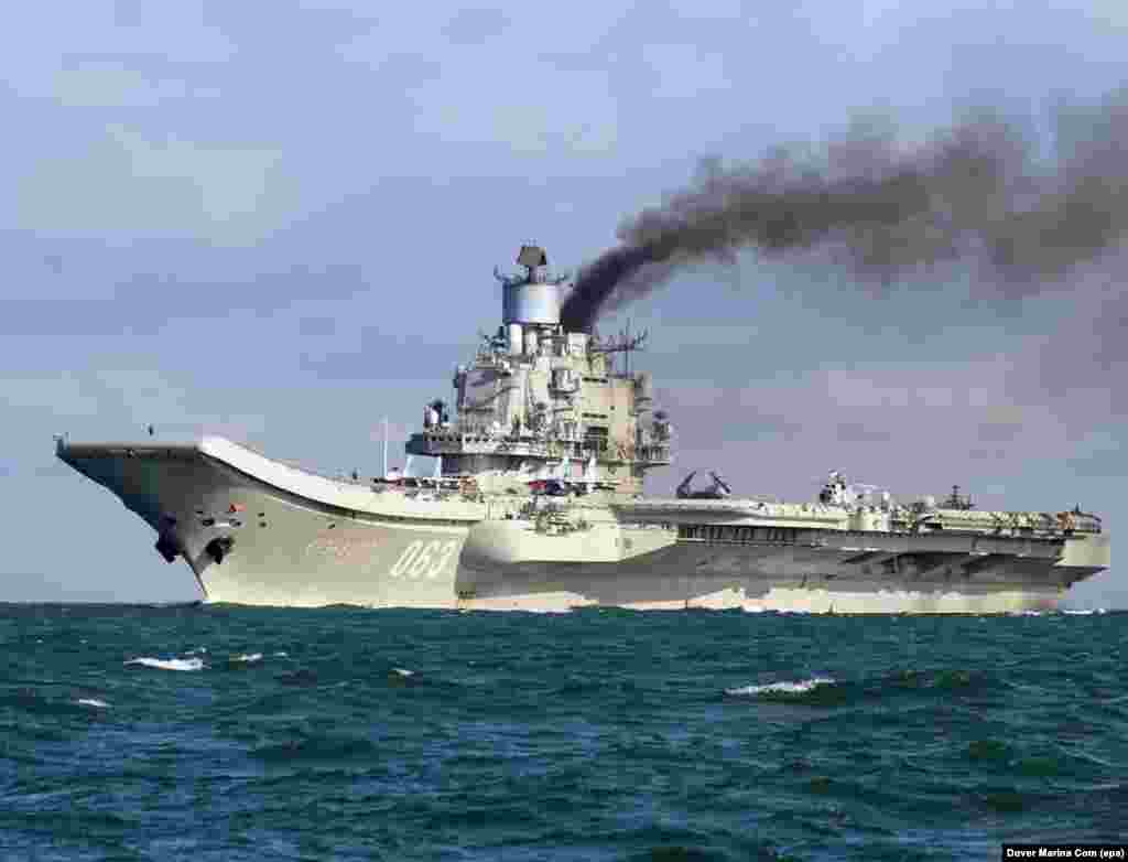 The Admiral Kuznetsov, billowing smoke as it passes through the English Channel on October 21, 2016. The diesel-powered carrier has attracted ridicule on Russian social media for its plume of black exhaust, but the apparent purpose of the vessel's mission to Syria is deadly serious.