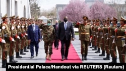 U.S. Defense Secretary Lloyd Austin (center) walks past a guard of honor during his visit to Kabul on March 21. 
