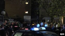 Police gather outside a polling station in a school after unknown persons attacked the site during the municipal elections in the ethnically divided city of Kosovska Mitrovica on November 3.