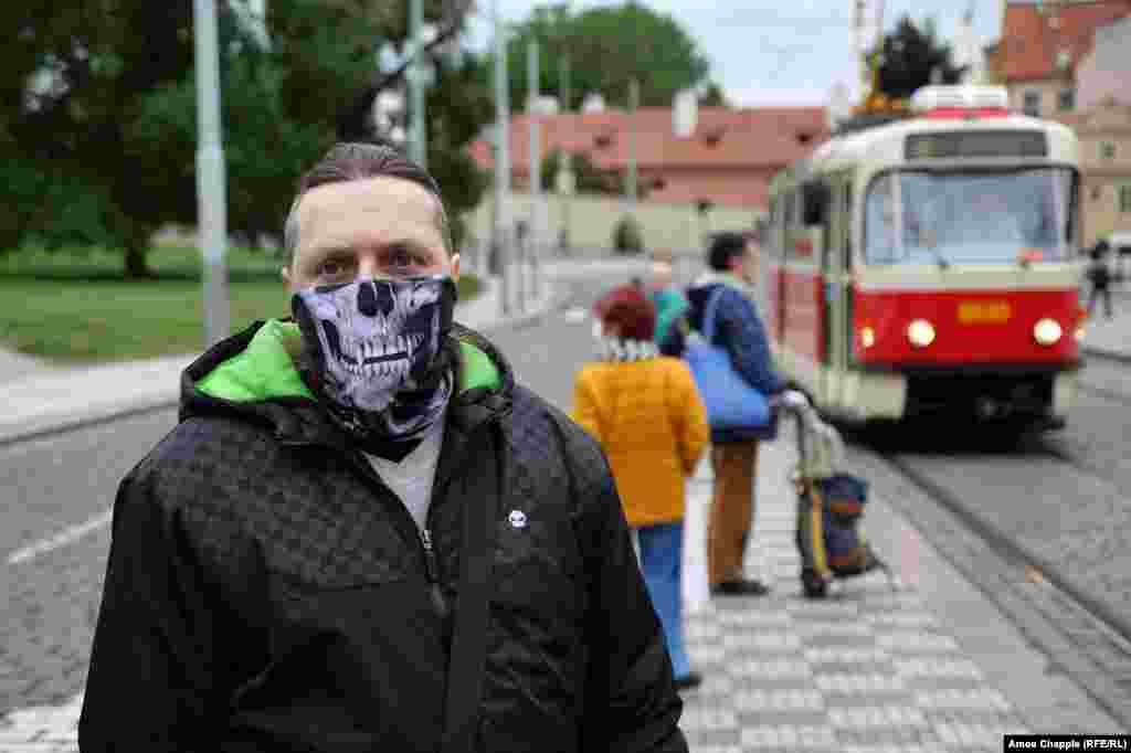 Чоловік чекає на трамвай 25 травня. Хоча правила, що вимагають носіння масок для обличчя в громадських місцях, були різко послаблені, люди в Чехії зобов'язані носити маски в громадському транспорті і в багатьох будівлях