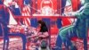 A woman walks past a mural depicting an Iranian official in civilian clothing sitting across the table from an American official wearing military fatigues painted on the outer walls of the former US Embassy in Tehran.