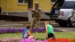 A Ukrainian serviceman stands guard in the city of Schastye in the Luhansk region late last month.