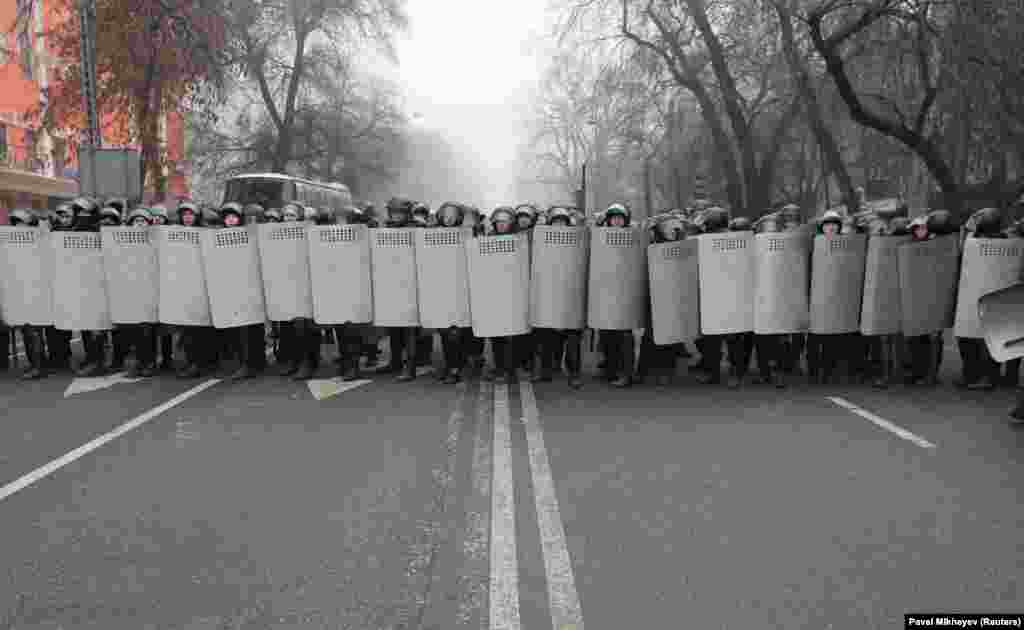 Police form a wall of shields in Almaty on January 5. 