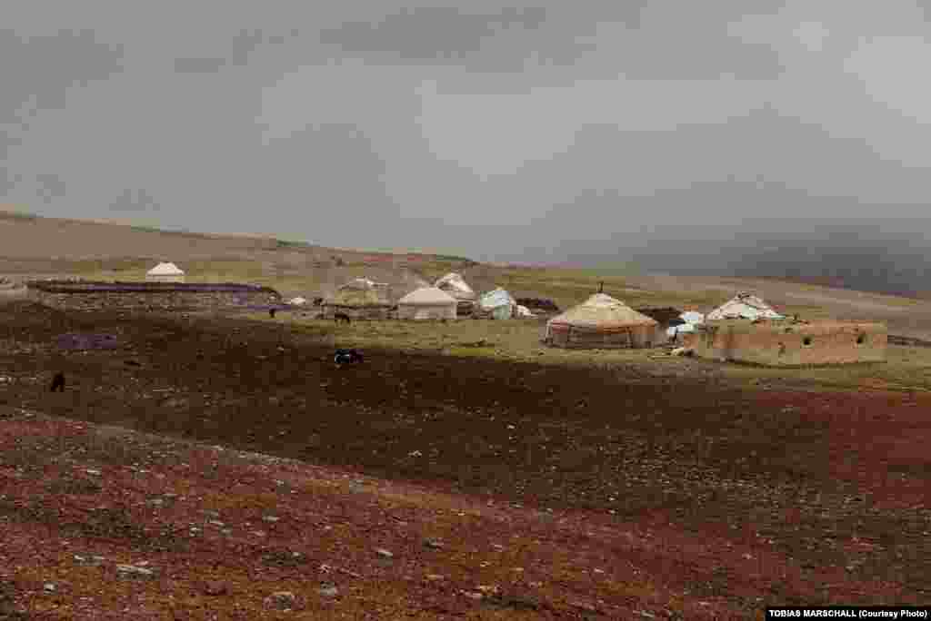A half-dozen yurts, a corral, a mud-brick guesthouse, and a mosque -- a typical summer camp for nomadic herders at Hasht Goz at the entrance of the Little Pamir valley