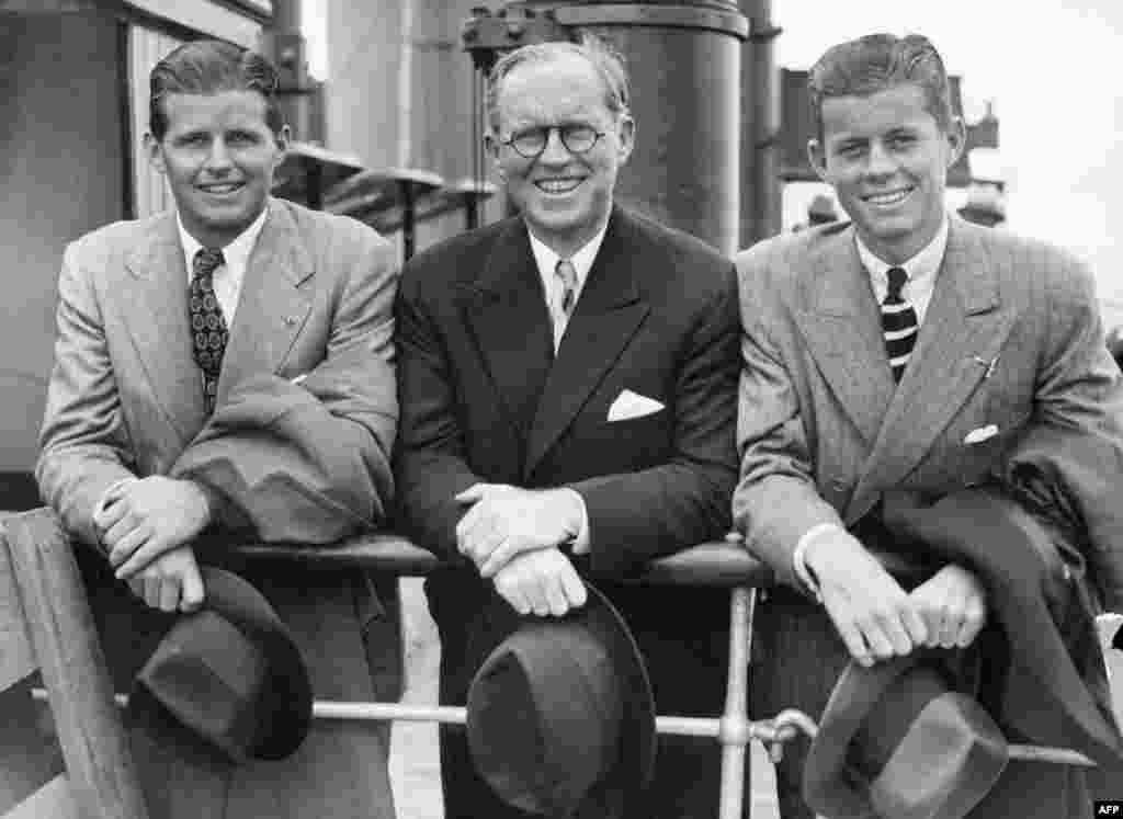JFK (right) and his older brother, Joseph P. Kennedy, Jr. (left), beside their father, Joseph, in Southampton, England on the deck of French "Normandy" cruiser liner after their arrival from the United States on July 2, 1938. Joseph was later killed in action, in 1944, during World War II.