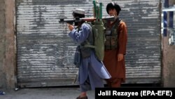Members of private militia patrol in Herat city following intense battle with Taliban militants.