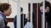 Sofya Malashevich (center) and Tsikhan Klyukach (right) in court on January 14