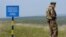 A Ukrainian border guard near one of 150 posts set up by Ukraine along its border with Moldova's breakaway region of Transdniester