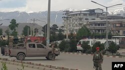 Afghan security personnel arrive at the scene of an attack near the Marshal Fahim Military Academy in Kabul on May 30.