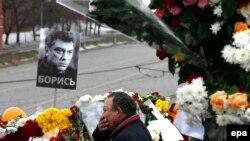 A man reacts at the site where veteran Russian opposition leader Boris Nemtsov was shot dead in central Moscow.