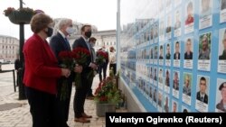 Сенатори CIF Джин Шахін, Кріс Мерфі та Роб Портман покладають квіти до меморіалу українським військовим, загиблим в ході бойових дій на Донбасі, Київ, 2 червня 2021 року