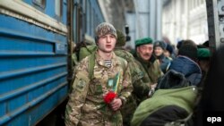 Relatives and friends meet returning Ukrainian soldiers in Lviv on February 23.