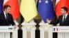 Ukrainian President Volodymyr Zelensky (right) and French President Emmanuel Macron attend a press conference following their talks in Kyiv on February 8.