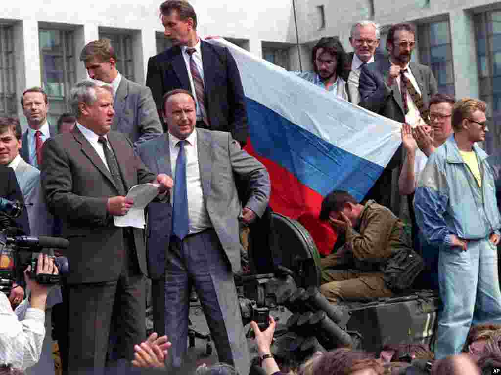 Russian President Boris Yeltsin stands atop a tank in Moscow on August 19, 1991, and calls for a general strike.