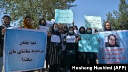 Afghan women hold banners and placards at a Kabul protest on September 8.