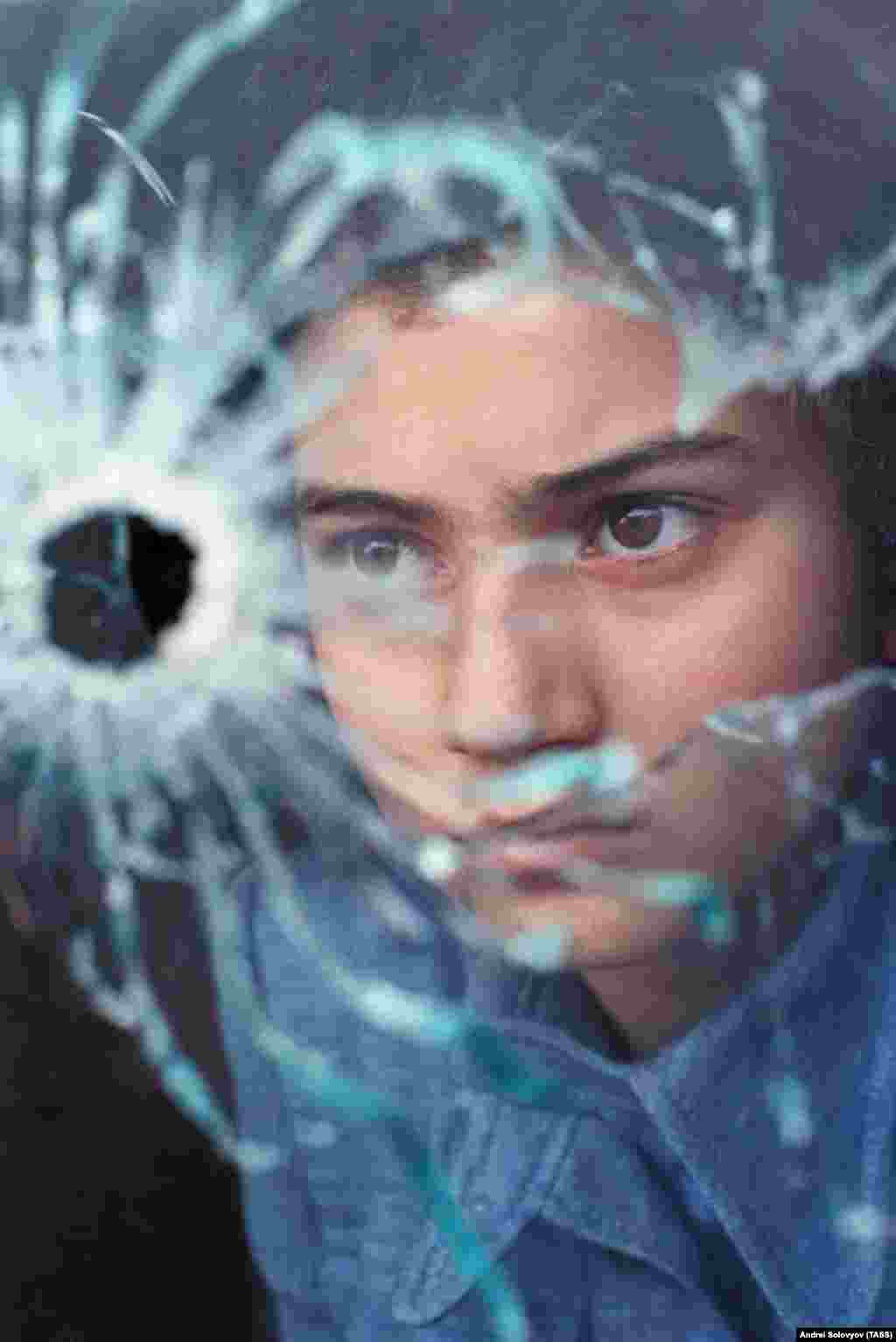 Дитина дивиться крізь отвір від кулі, Баку, 22 січня 1990 року.  