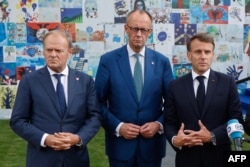 Premierul polonez, Donald Tusk (stânga,) cancelarul german Friedrich Merz și președintele francez Emmanuel Macron, vorbind jurnaliștilor după un summit al Comunității Politice Europene, la Tirana, pe 16 mai 2025