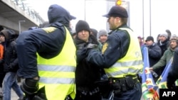 Police push back activists during a protest in Copenhagen