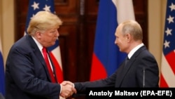 U.S. President Donald Trump (left) and Russian President Vladimir Putin shake hands at their summit in Helsinki in July.