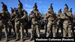 Moldovan soldiers line up next to military vehicles received by the United States at a ceremony in Chisinau, Moldova, on February 18. On April 9, the EU is set to green-light the bloc's largest-ever military aid package to the country, which borders Ukraine.