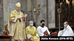 Primate of the Hungarian Catholic Church, Archbishop of Esztergom-Budapest Cardinal Peter Erdo (left) celebrates the Christmas Day mass in Esztergom, Hungary, in 2020.
