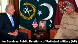 U.S. peace envoy Zalmay Khalilzad (left) talks with Pakistani Army Chief General Qamar Javed Bajwa in 2018.