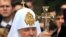 An Orthodox priest blesses demonstrators protesting against Patriarch Kirill's visit to Ukraine.