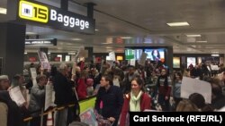 Прибулі з-за кордону проходять повз активістів, що вітають їх, аеропорт імені Даллеса під Вашингтоном, 30 січня 2017 року