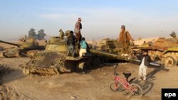 Children in Afghanistan play in a junkyard of Soviet-era tanks left over from Moscow's disastrous occupation of the country between 1979 and 1989.