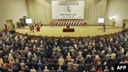 Lawmakers take the oath of office during the first session of Iraq's new parliament on June 14 in Baghdad.