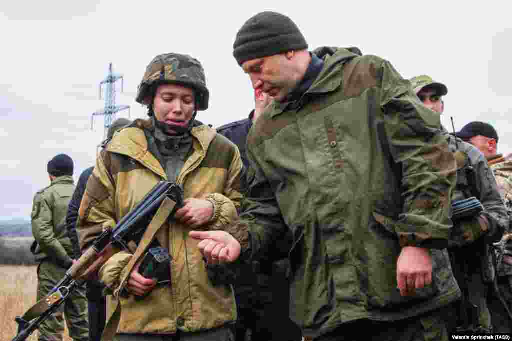 Ватажок угруповання «ДНР», що визнане в Україні терористичним, Олександр Захарченко дарує свій автомат Калашникова 22-річній жінці, яка брала участь у змаганнях серед бойовиків підрозділу «Витязь». Окупована частина Донеччини, 9 листопада 2017 року