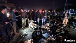 Security forces inspect the site of a car bomb attack in a marketplace in Najaf, Iraq on November 28.