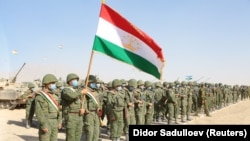 Members of Tajikistan's armed forces line up during joint military drills involving Russia, Uzbekistan, and Tajikistan at the Harb-Maidon training ground near the border with Afghanistan on August 10.