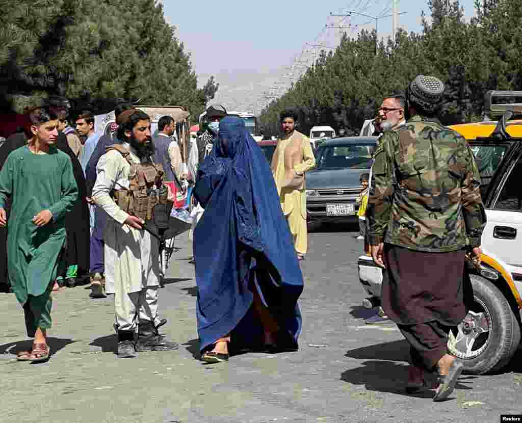 A woman covered by a burqa on the street in Kabul on August 27.   A female Kabul resident who spoke to RFE/RL by encrypted messaging said there was uncertainty in the Afghan capital about what Taliban rule will be like. "The spokesperson of the Taliban says they have changed and blah blah blah," the woman wrote. "But ordinary Taliban on the streets are so much different and rude, carrying guns."  