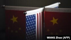 Trade tensions between the United States and China heated up on August 15 as Beijing warned that it "will not sit idle" if a US probe into its intellectual property practices leads to sanctions. / AFP PHOTO / WANG Zhao