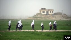 Girls walk home from school in Konduz Province. When it ruled Afghanistan, the Taliban banned girls from attending school.